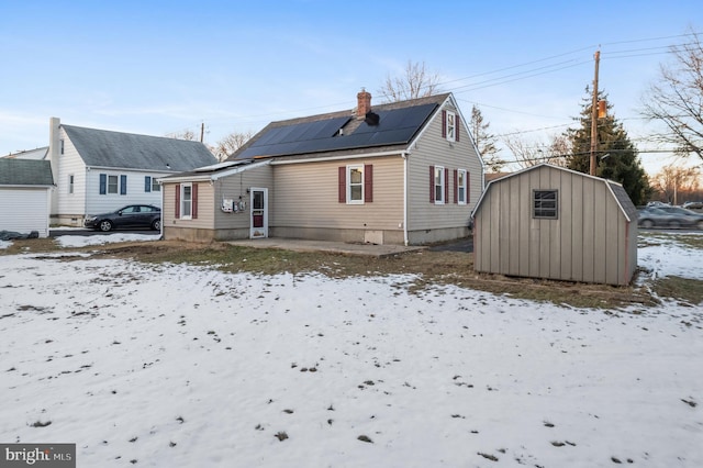 snow covered property with solar panels