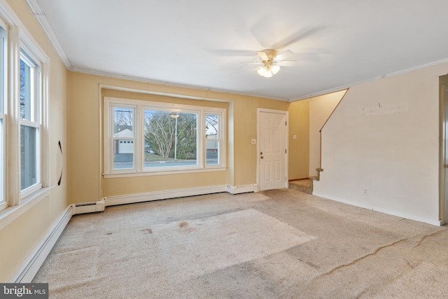 carpeted empty room featuring ornamental molding and a baseboard heating unit