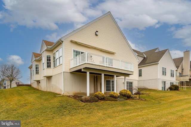 rear view of house featuring a lawn