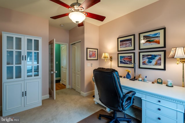 carpeted office with french doors and ceiling fan