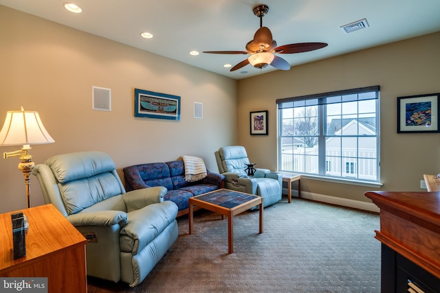 living room with ceiling fan and carpet flooring