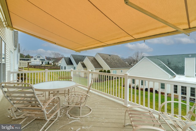 wooden terrace featuring a yard