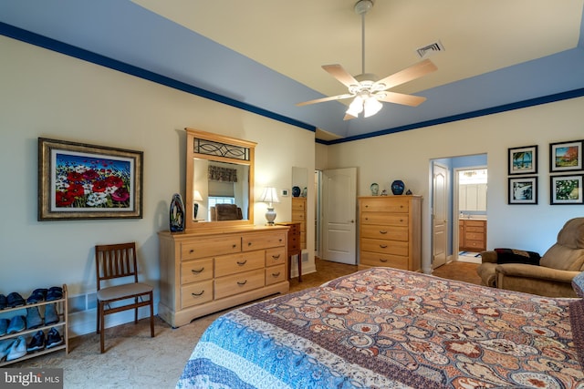 bedroom featuring crown molding, ceiling fan, and ensuite bathroom