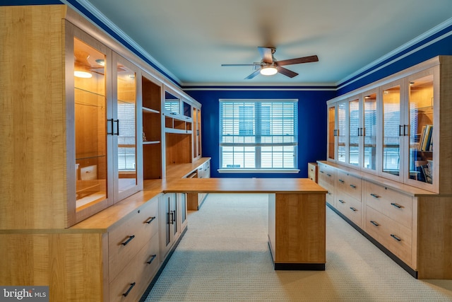 home office featuring light colored carpet, ornamental molding, and ceiling fan