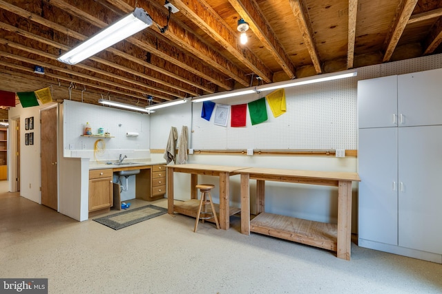 basement featuring sink and a workshop area