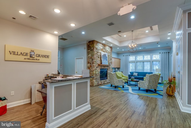 welcome area featuring a notable chandelier and a fireplace