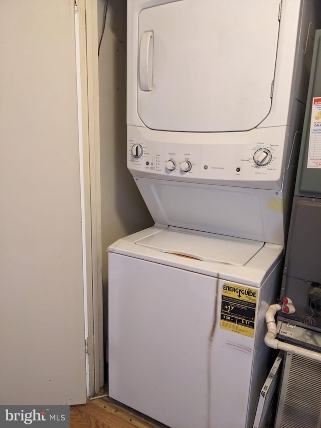 washroom featuring stacked washer / drying machine