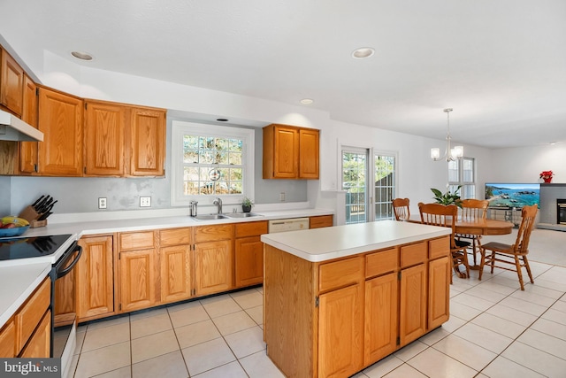 kitchen with black electric range oven, sink, hanging light fixtures, a center island, and light tile patterned flooring