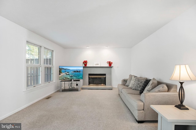 living room featuring light carpet and a brick fireplace