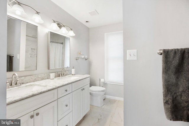 bathroom featuring vanity and toilet