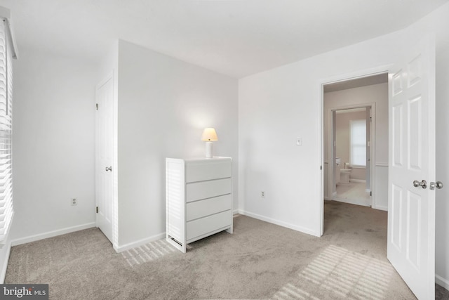 unfurnished bedroom featuring light carpet