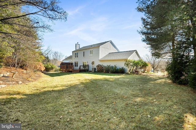 view of home's exterior featuring a deck and a lawn