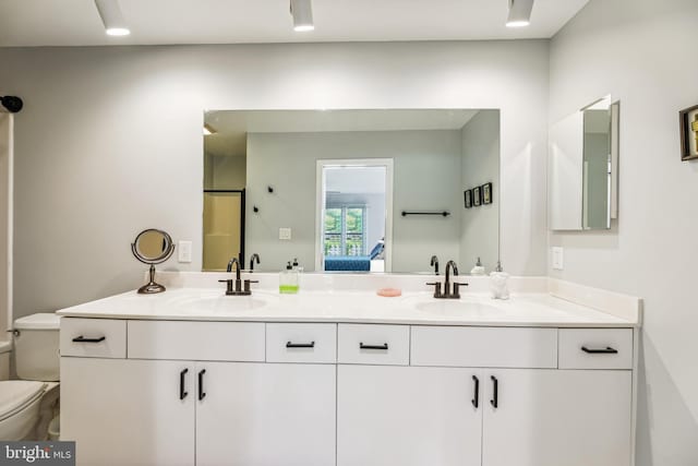 bathroom featuring vanity and toilet