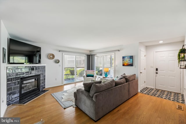 living room featuring a fireplace and hardwood / wood-style floors