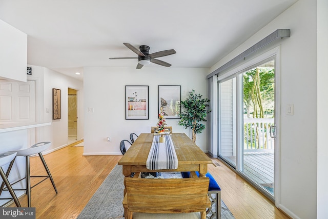 dining room with light hardwood / wood-style flooring and ceiling fan