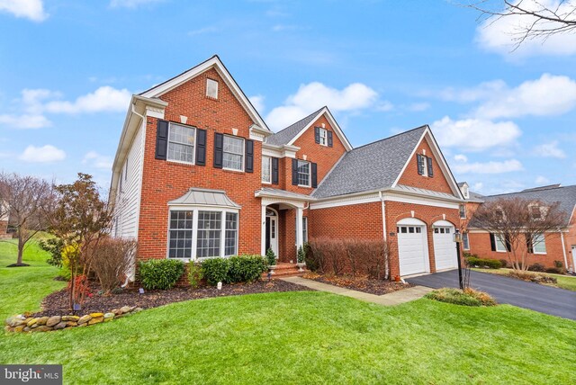 view of front of house with a garage and a front lawn