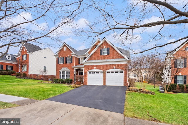 view of front of home with a garage and a front lawn