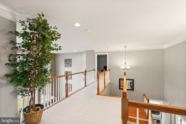 corridor with an inviting chandelier, carpet flooring, and crown molding