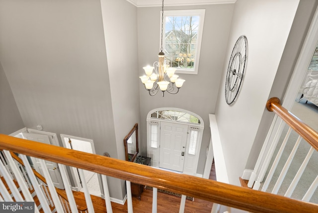 entrance foyer featuring wood-type flooring and a chandelier