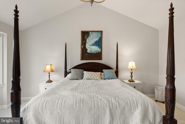 bedroom featuring vaulted ceiling and light carpet