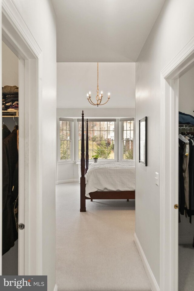 bedroom with a notable chandelier, a spacious closet, and a closet