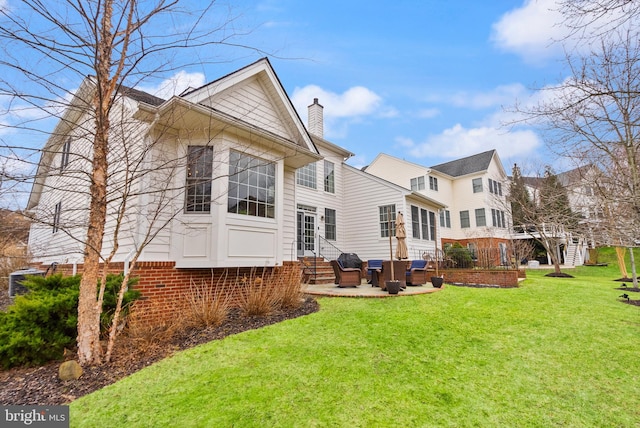 back of house featuring a yard and an outdoor hangout area