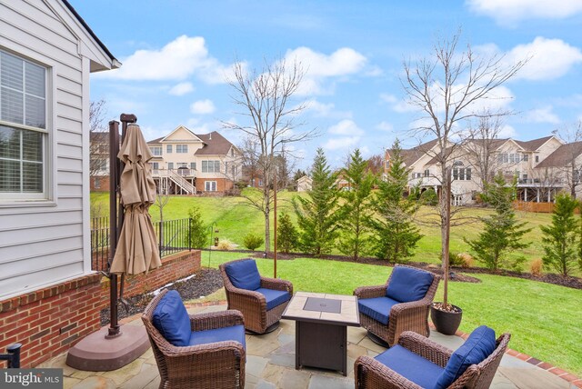 view of patio / terrace featuring an outdoor living space with a fire pit