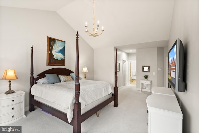 bedroom with light colored carpet, connected bathroom, a chandelier, and vaulted ceiling