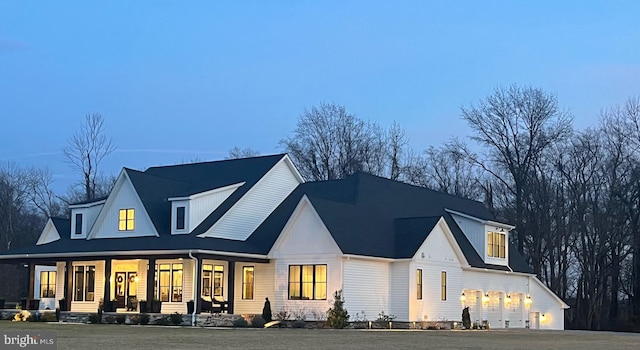 back house at dusk with covered porch