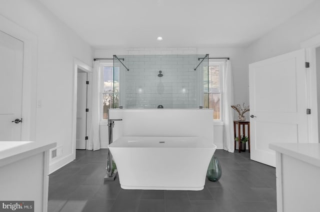 bathroom featuring tile patterned flooring, shower with separate bathtub, and plenty of natural light