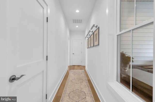 corridor with light wood-type flooring