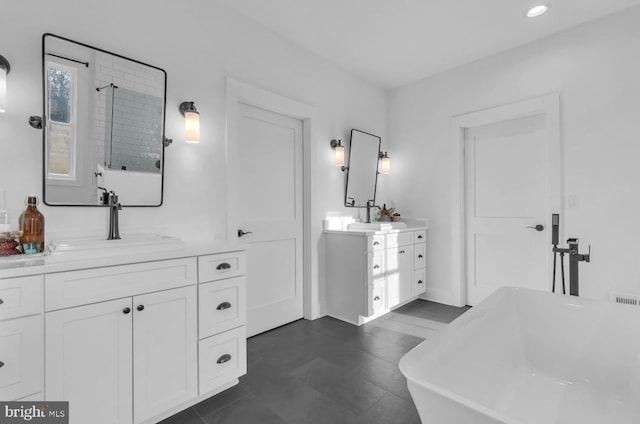 bathroom with vanity and a bath