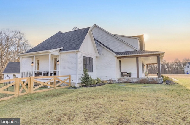 view of front facade with a yard and covered porch