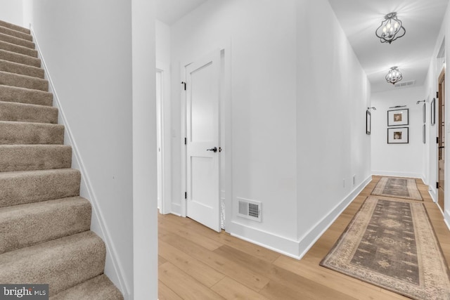 corridor with wood-type flooring