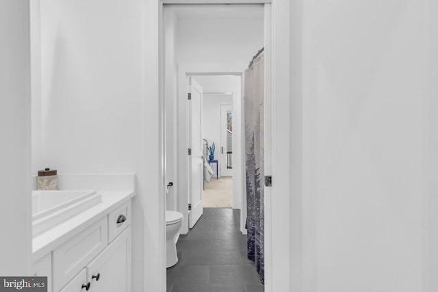 bathroom featuring vanity and toilet