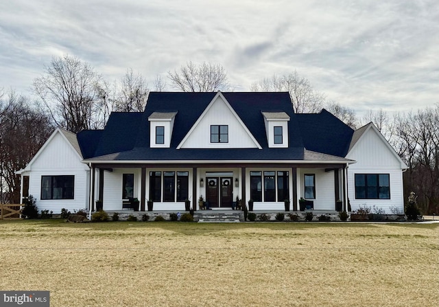 modern farmhouse style home featuring a front yard and covered porch