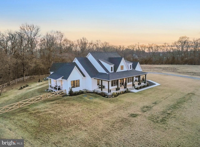 view of front of house with a yard and a porch