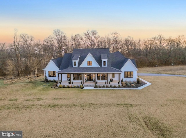 view of front of house featuring a porch and a lawn