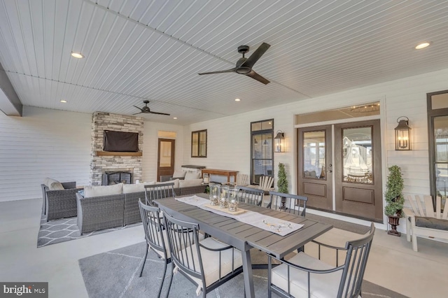 view of patio / terrace featuring an outdoor living space with a fireplace and ceiling fan