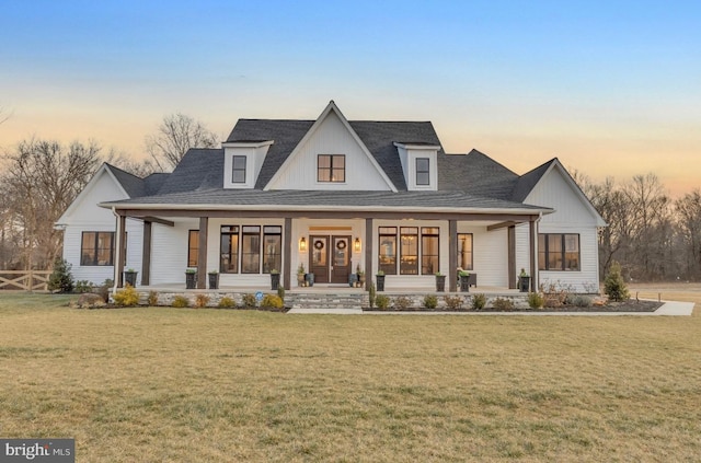 modern inspired farmhouse with a porch and a yard