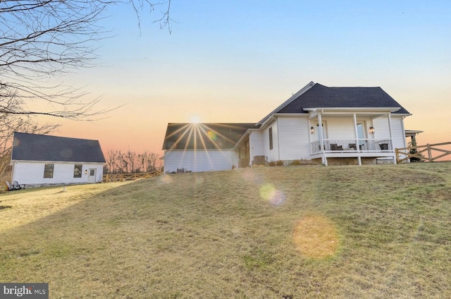 view of front facade featuring a lawn and covered porch