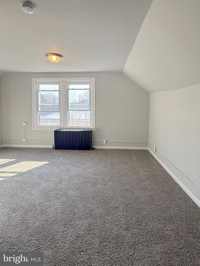 additional living space with lofted ceiling, carpet flooring, and radiator heating unit