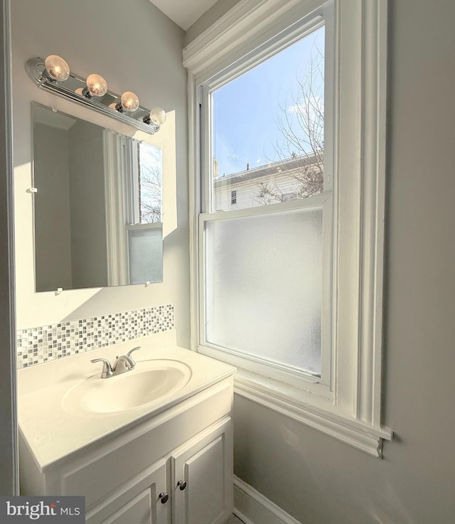 bathroom featuring tasteful backsplash and vanity