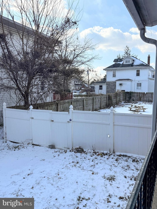 view of yard layered in snow