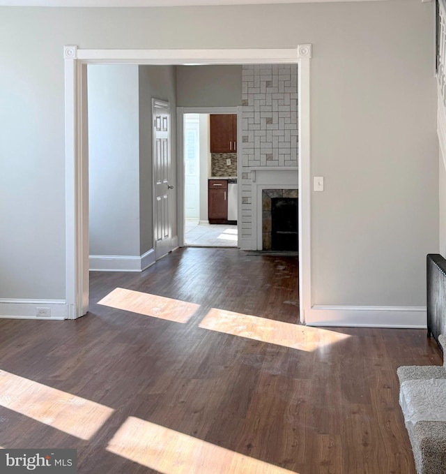 interior space with a fireplace and dark hardwood / wood-style flooring