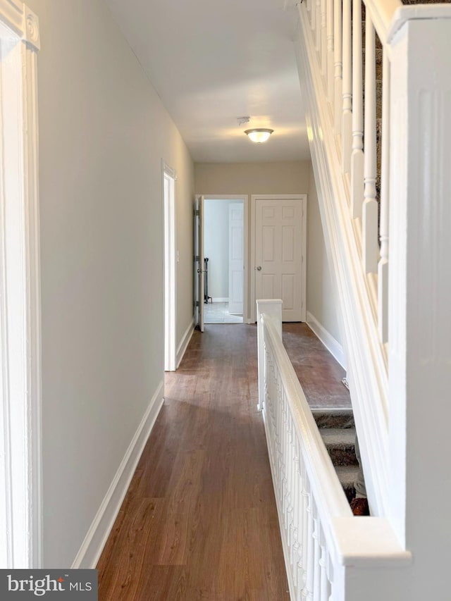 hallway with dark hardwood / wood-style floors