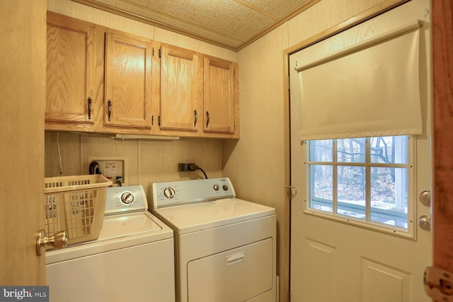 laundry room with cabinets, ornamental molding, and washer and dryer