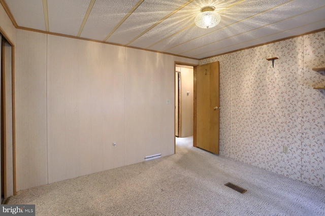 carpeted empty room featuring crown molding