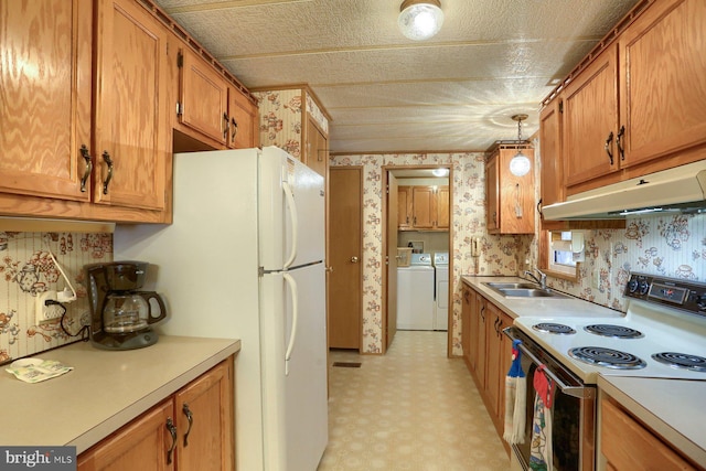 kitchen with pendant lighting, sink, electric range oven, independent washer and dryer, and white refrigerator