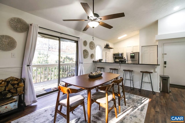 dining area with dark hardwood / wood-style flooring, vaulted ceiling, and ceiling fan